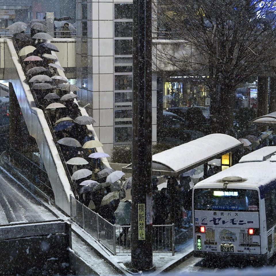Saitama, Japan.  Hopefully there will be enough space for the entire queue that has lined up in front of a bus.  It is well known that standing in the snow at drafty stops is not particularly pleasant.